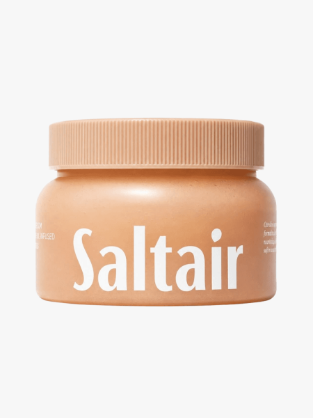 Saltair Body Scrub in branded tub component on a light gray background