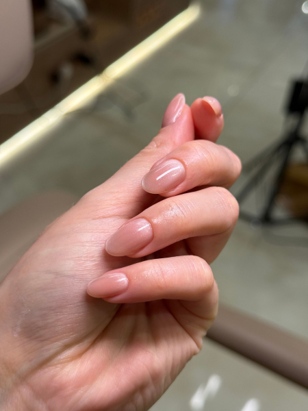 Writer Lucy Abbersteen shows off her finished Ukrainain manicure in a shimmering neutral pink shade.